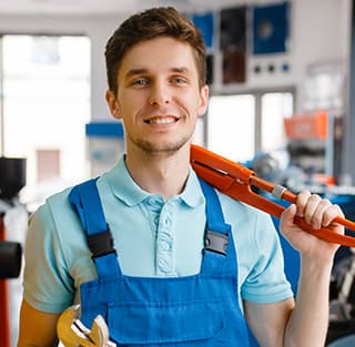 A man in overalls with a wrench, illustrating Titan Exteriors and his role in home improvement and repairs. A man in overalls with a wrench, illustrating Titan Exteriors and his role in home improvement and repairs.